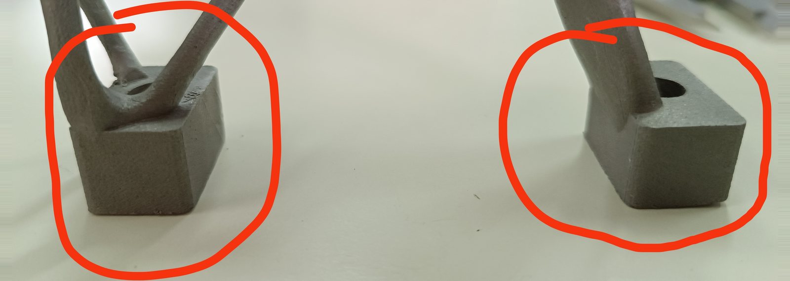 The two square mounting feet of the 3D-printed 316L stainless motor mount, each circled in red marker to flag it as out of tolerance