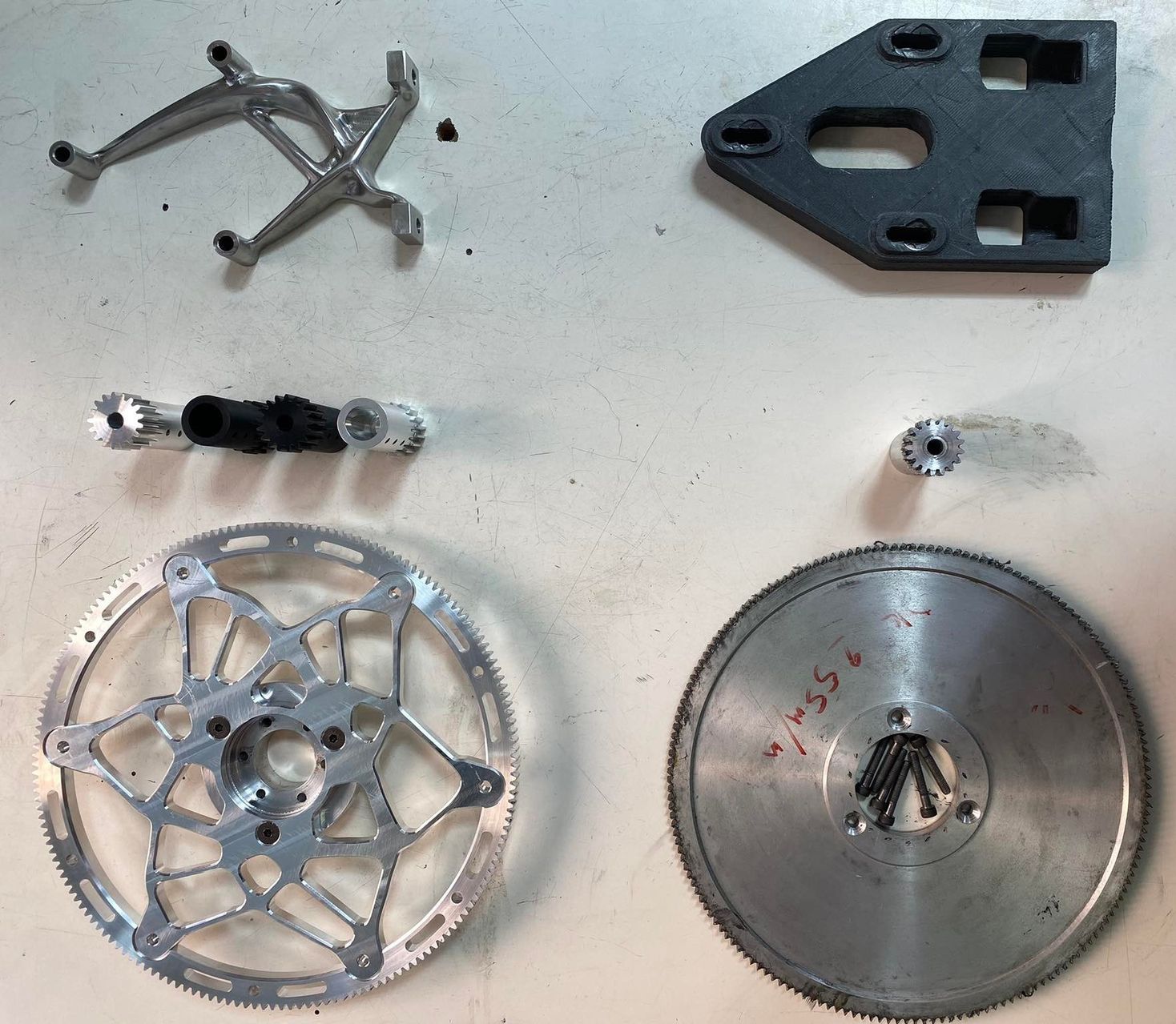 New motor mount, shaft and driven gear next to the original parts they replaced
