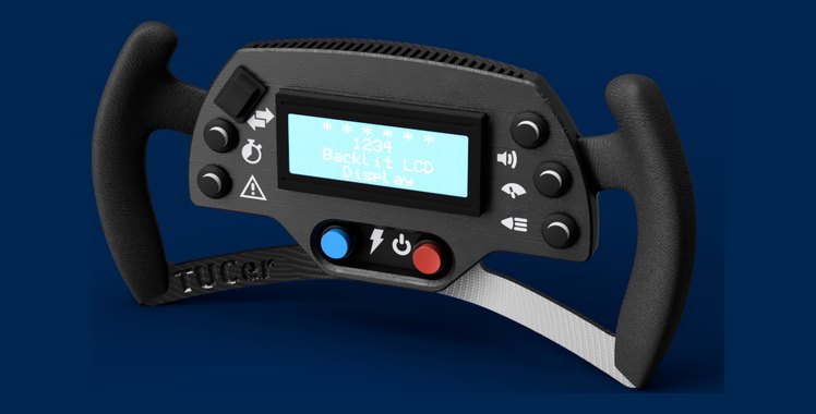 Render of the second-iteration TUCer steering wheel — backlit LCD panel, moulded grips and a TUCer-embossed lower spoke